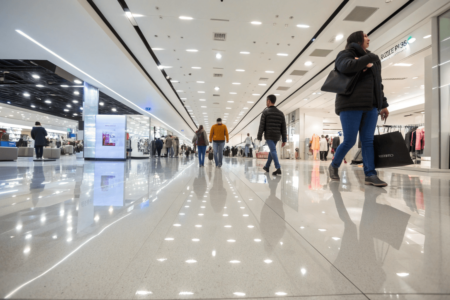 Busy retail store with heavy customer foot traffic walking on glossy epoxy flooring during peak shopping