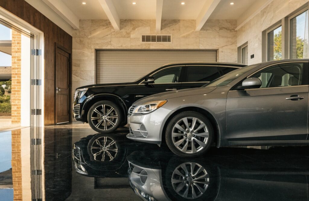 Epoxy garage floor in Sunshine Coast home with glossy finish and two parked vehicles
